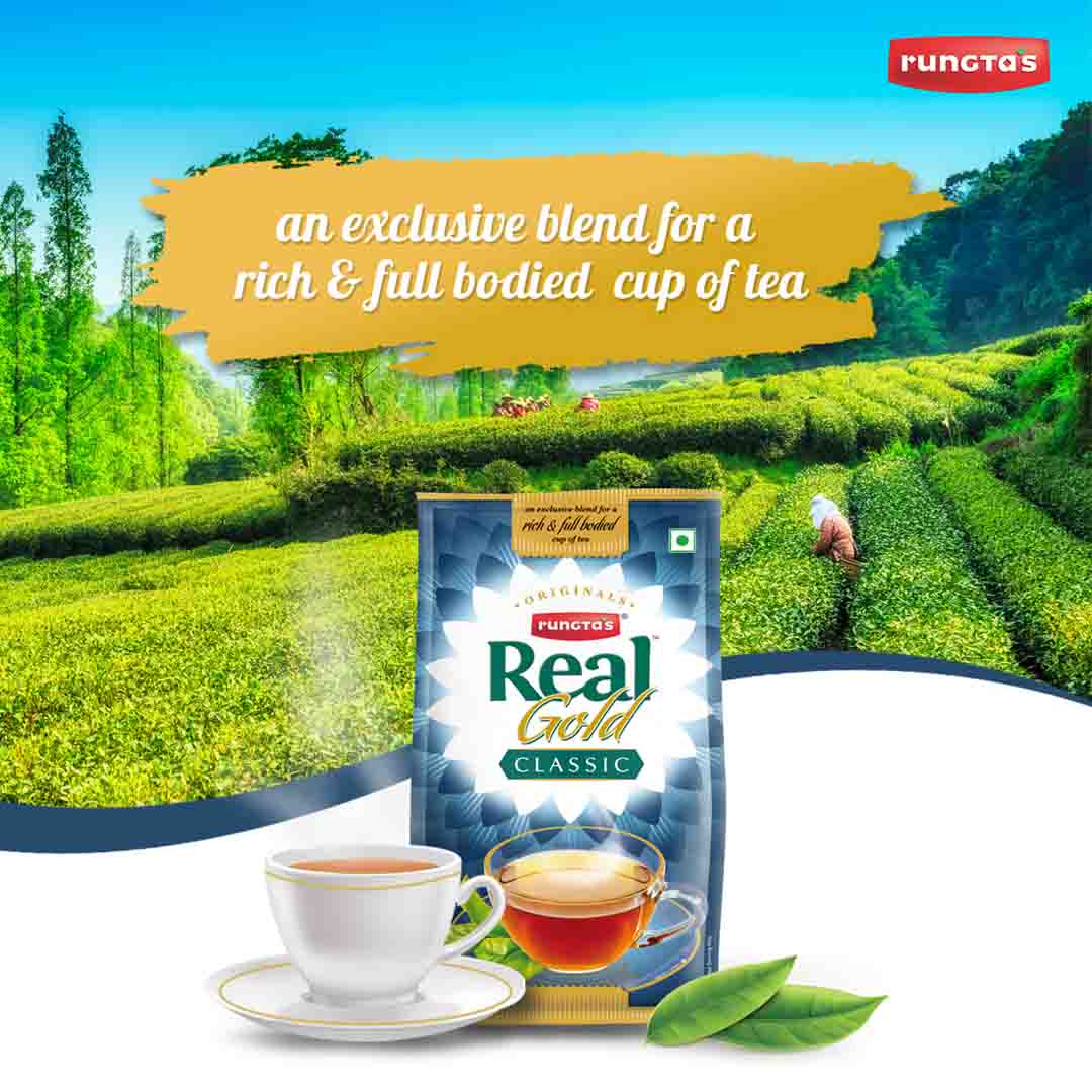 Rungta's Real Gold Classic Darjeeling tea packet, a premium blend for a rich and full-bodied cup of tea. The packaging features a blue and gold design with the brand logo and the product name. The image also shows a steaming cup of tea and a tea plantation in the background.